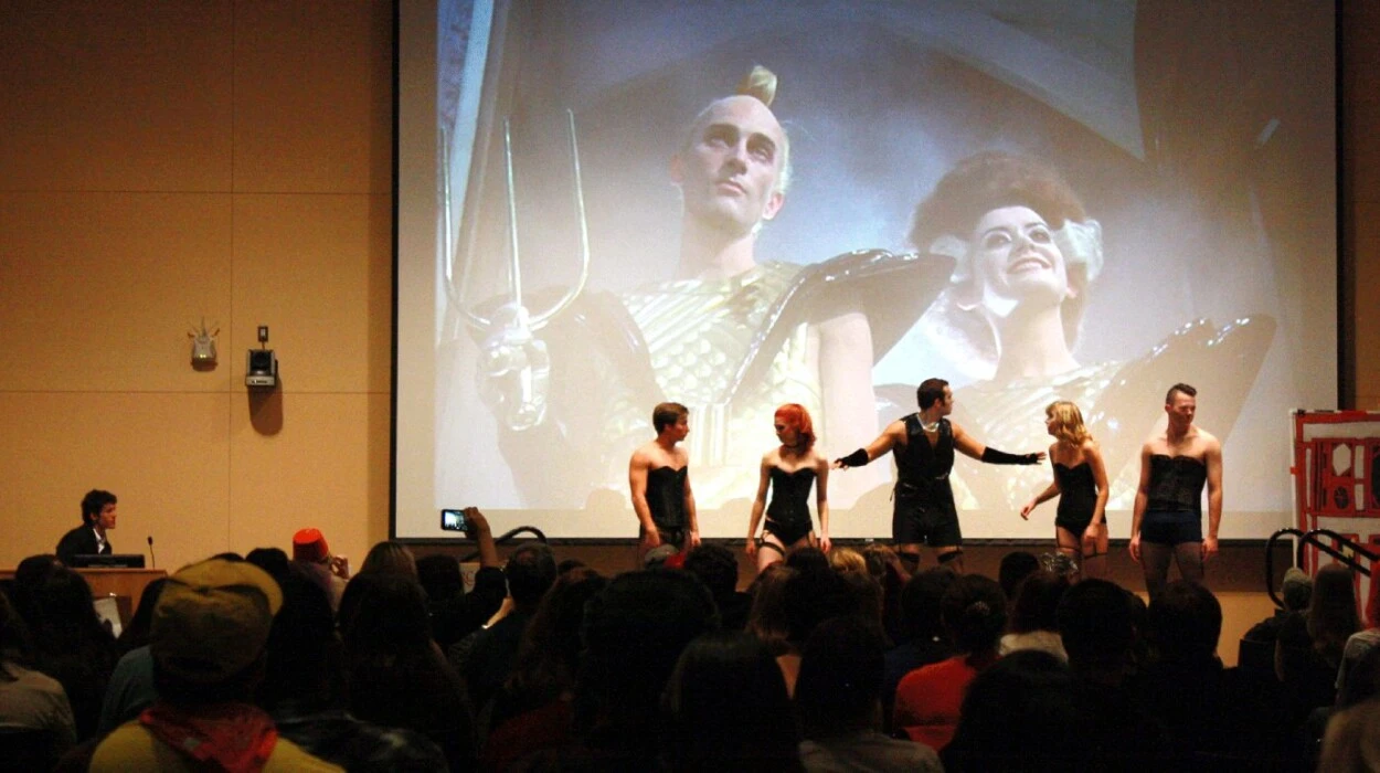Students perform the play The Rocky Horror Picture Show in front of live audience.