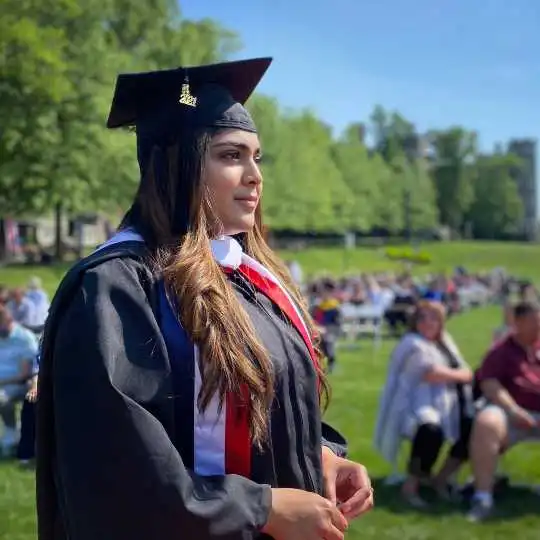 Student at commencement in cap and gown