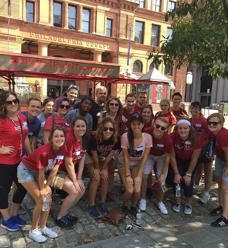 Group of honors students on a historic brick street in Philadelphia.