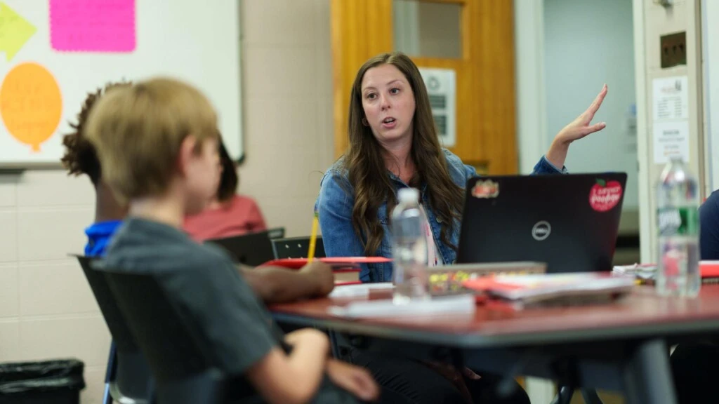 A student-teacher teaches children.