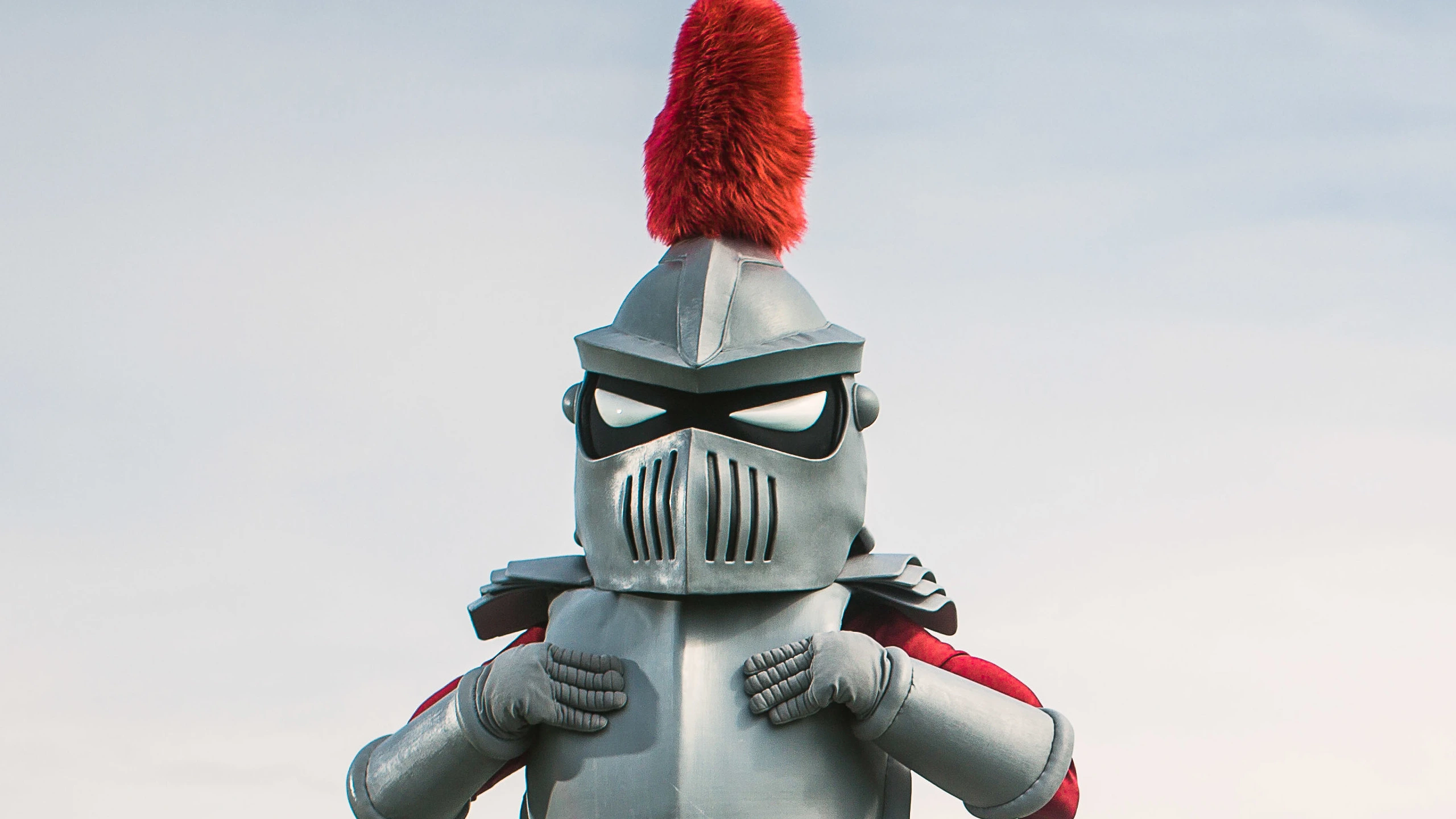 The Knight mascot stands with his hands at his chest