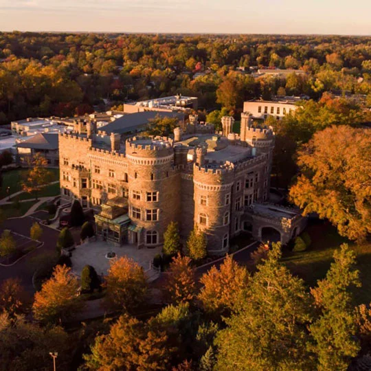 Aerial view of Grey Towers in golden evening sunlight