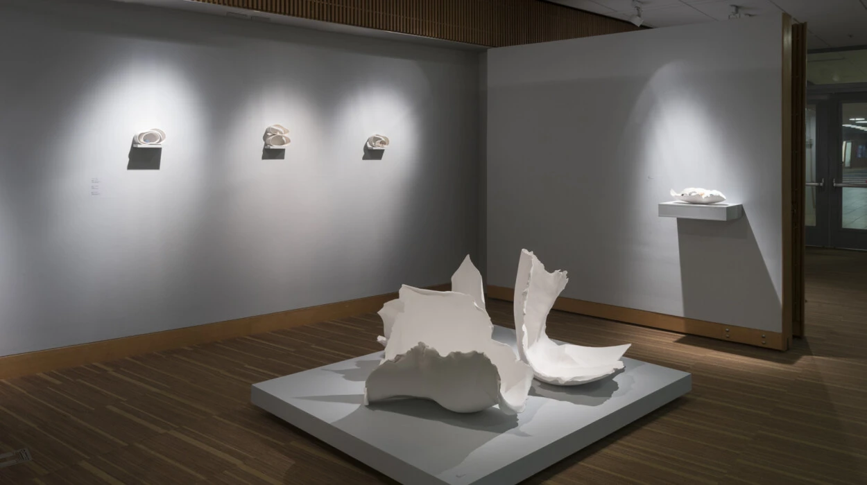 A display in an art gallery, showing a ceramic piece that looks to be intentionally broken