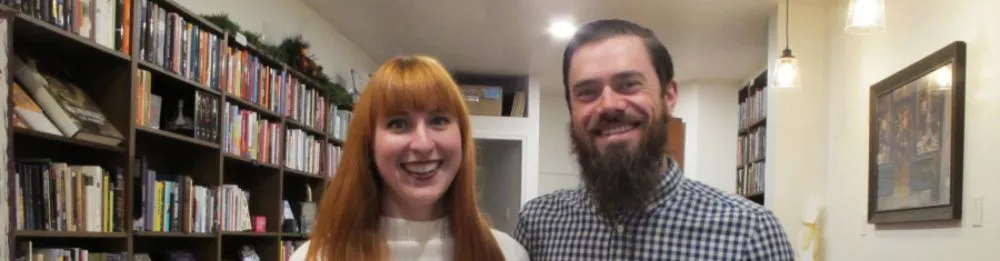 Two people standing together in a library