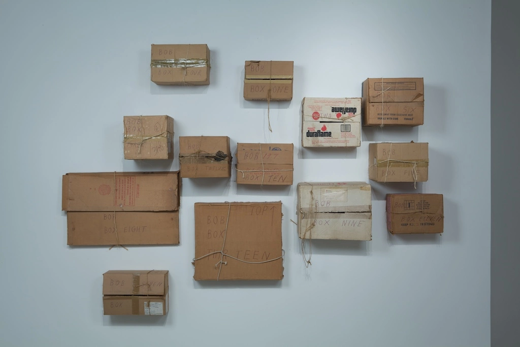 Different box types connected to a wall to make an art installation