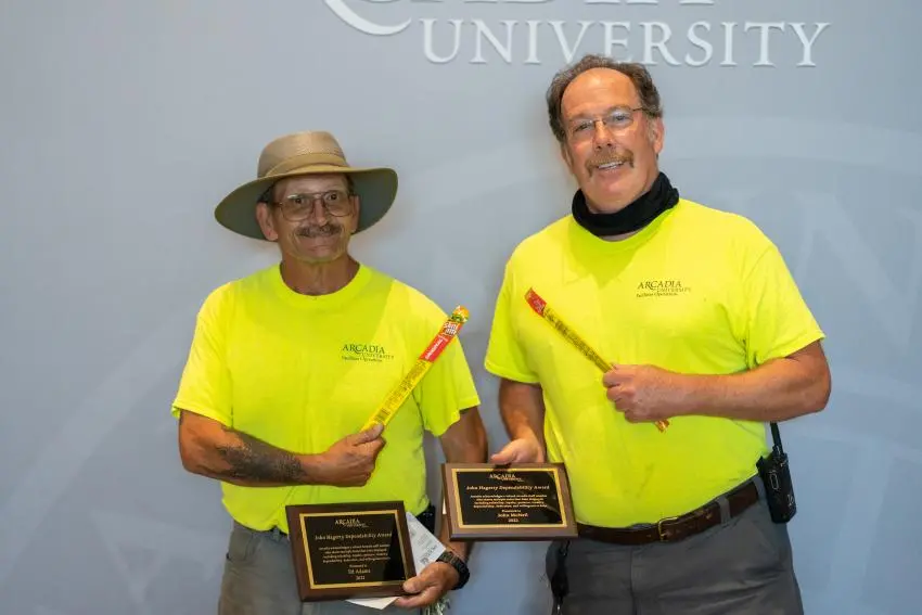 Ed Adams and John McNeil, recipients of the John Hagerty Dependability Award, displaying their award plaques
