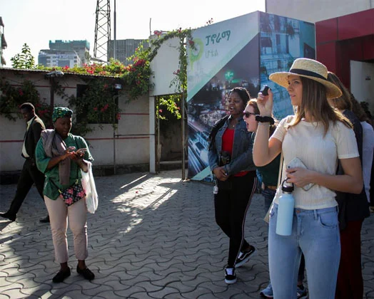 A student poses with local people while visiting abroad.