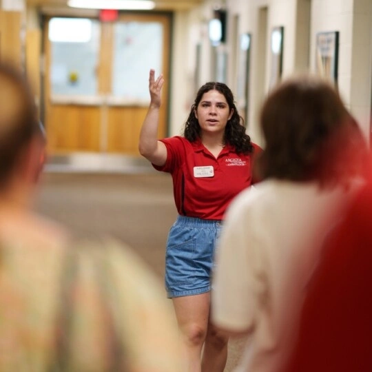 An ambassador giving a tour inside one of the buildings