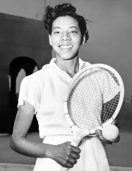 Tennis legend Althea Neale Gibson posing with a tennis racket