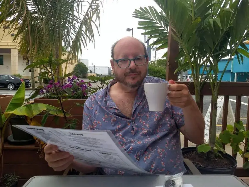 Dr. Appelbaum seated at an outdoor cafe in Greece