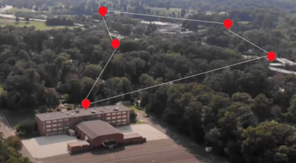 An bird's eye view of Arcadia University with five red plotted point markers drawn together in a grid.