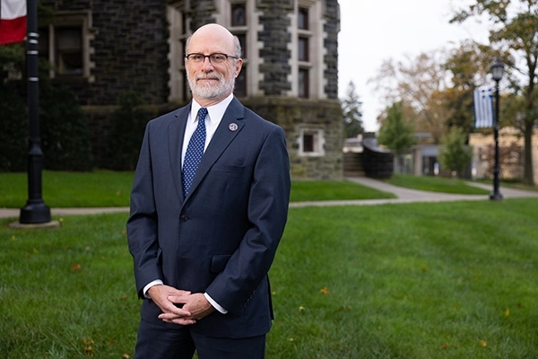 Jeff Rutenbeck, Ph.D. Provost, Senior Vice President for Academic Affairs stands in front of Arcadia's Castle.