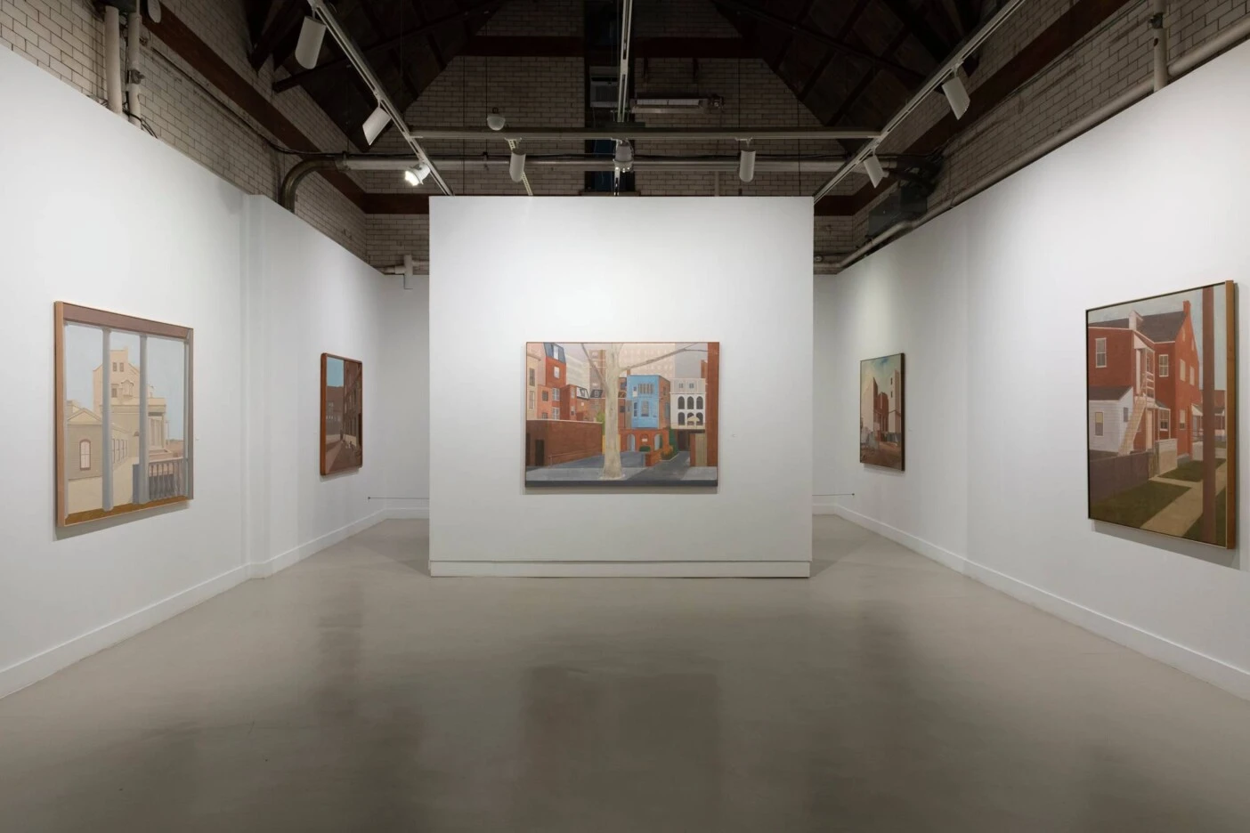 An art gallery displaying painted artworks of different buildings