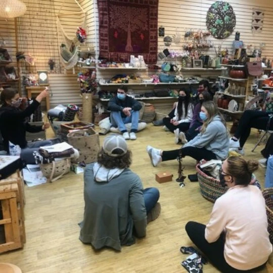 Students gather on the floor and in chairs