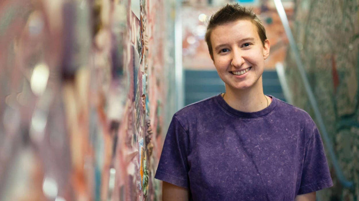 Arcadia student by a painted artsy wall.