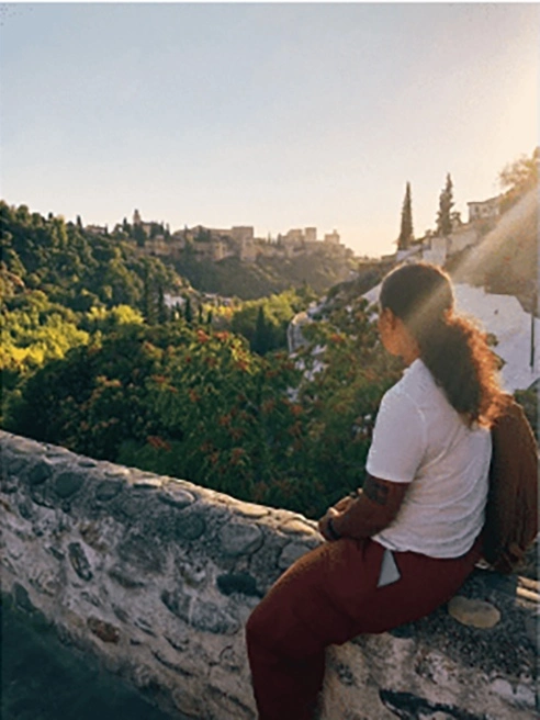Arcadia student Emily Cruz Pineda looks at the skyline during a sunset in Granada, Spain.