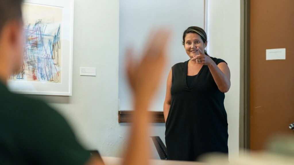 Professor Megan Elliott calls on a student in an art education class.