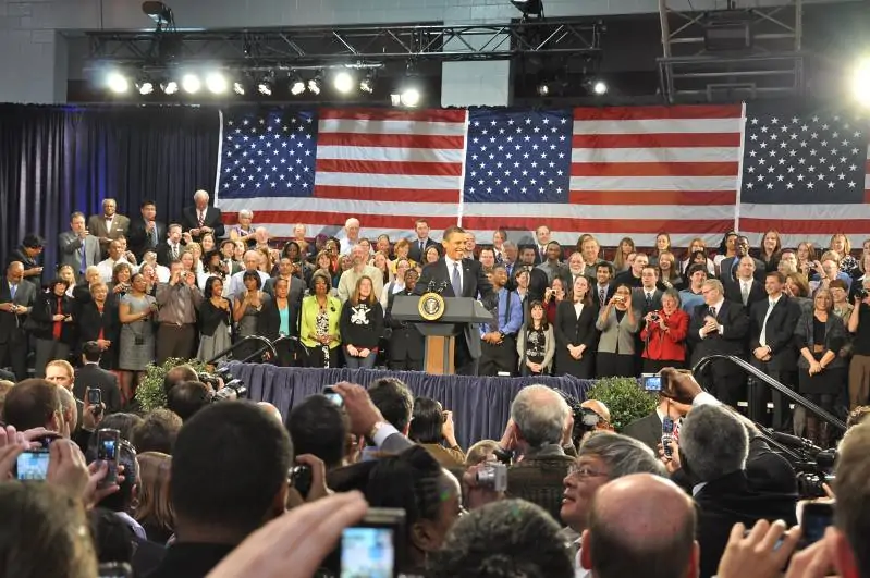Barack Obama standing at a podium for a press conference