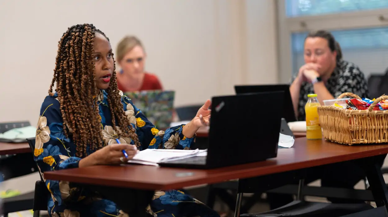 A graduate student participates in class