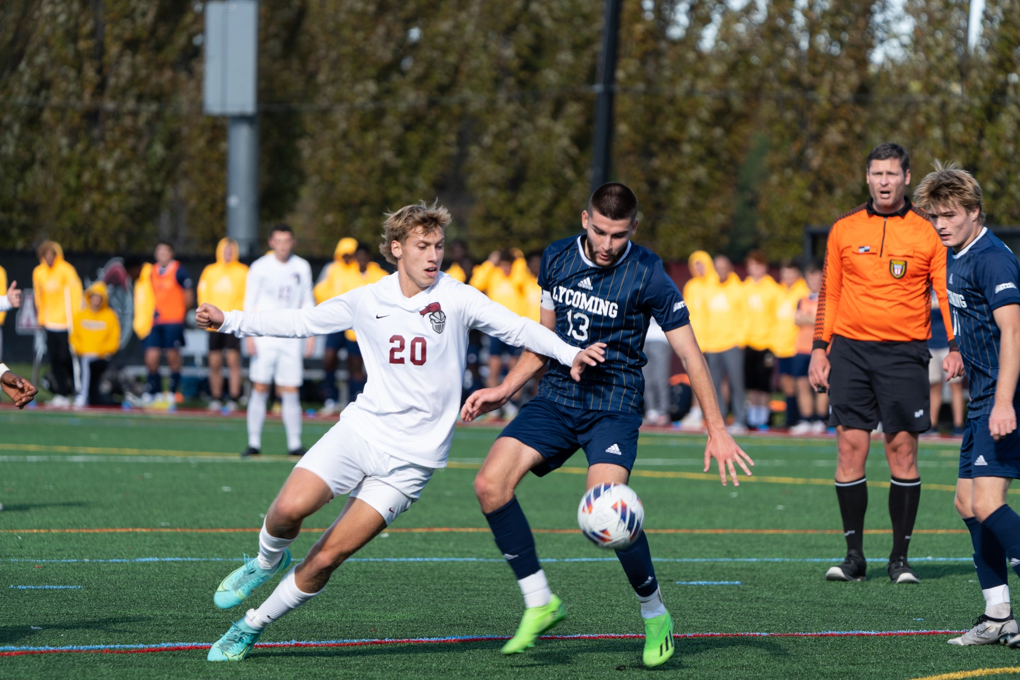 A men's soccer player for the Knights steals the ball from a player for Lycoming 