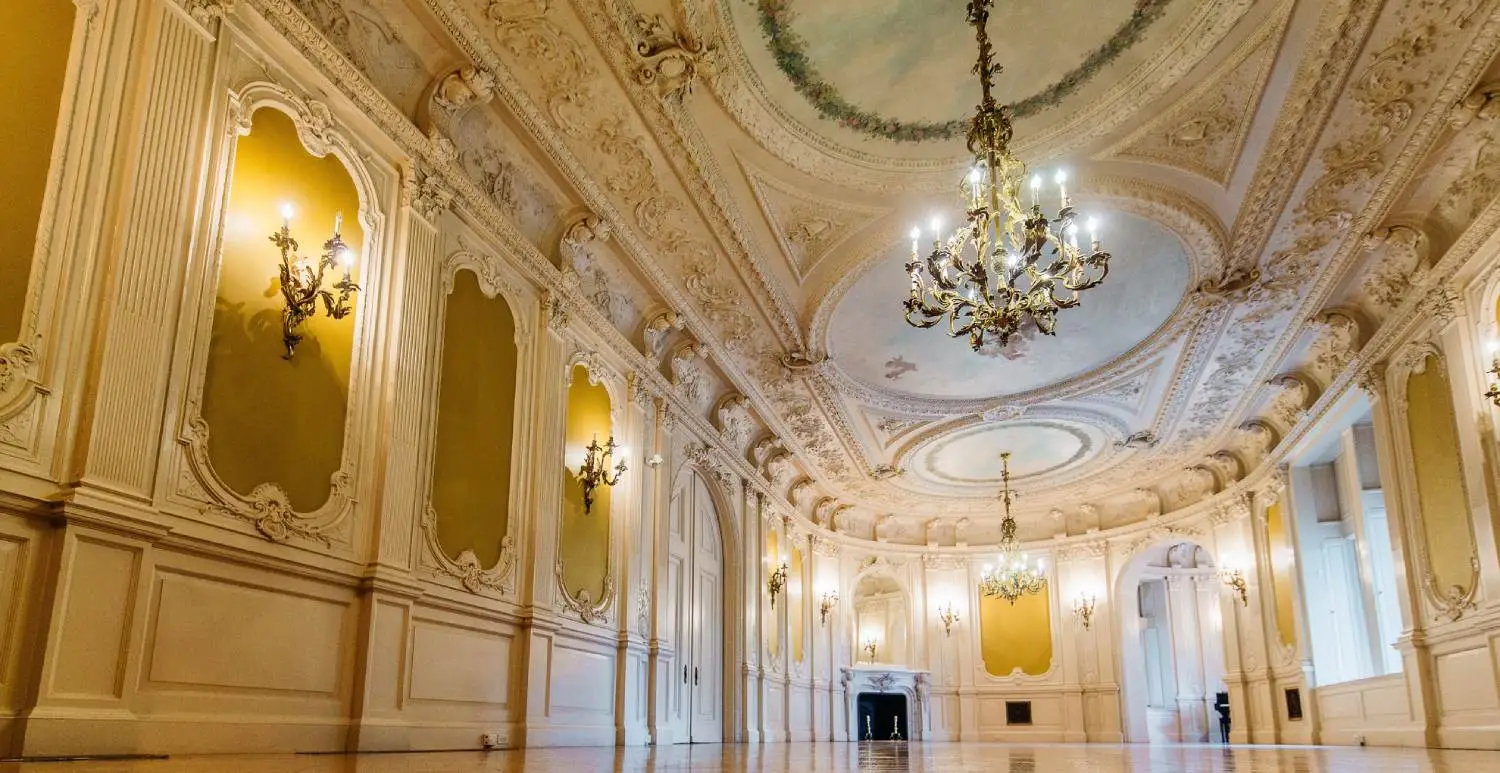 Greys Tower Castle interior room with ornate ceiling and chandeliers