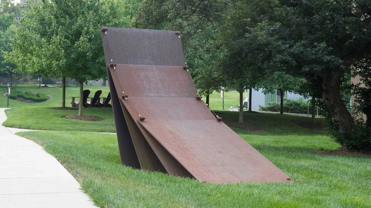 a large metal sculpture that is reminiscent of dominoes falling