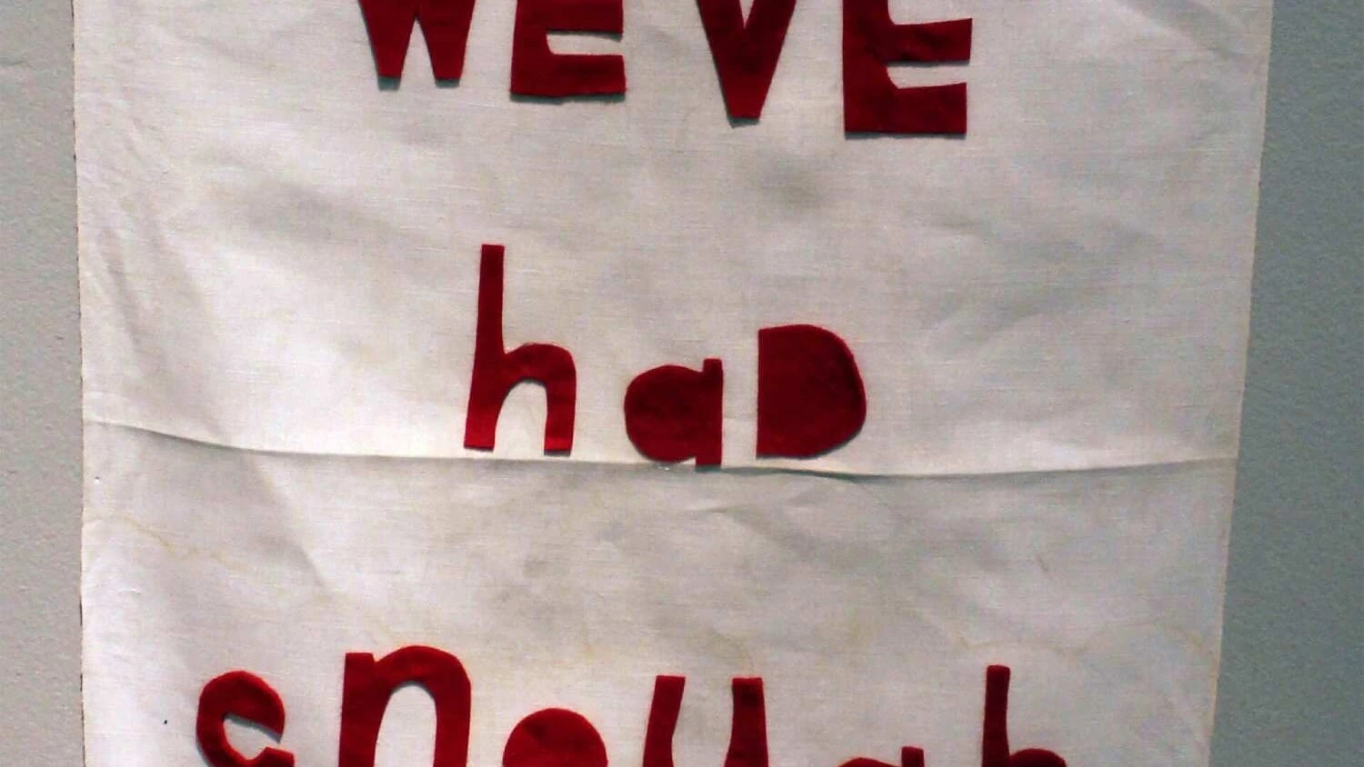 a vintage handkerchief with the words we've had enough in red felt letters