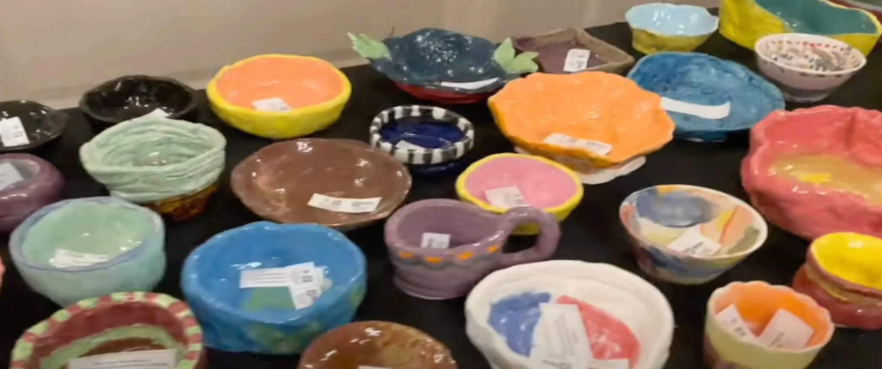 Empty Bowl Dinner 2022, a table full of handmade ceramic bowls for the fundraiser