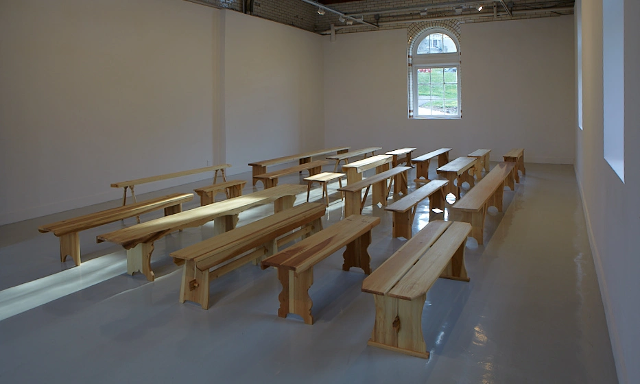 three rows of wooden benches in the Spruance Gallery