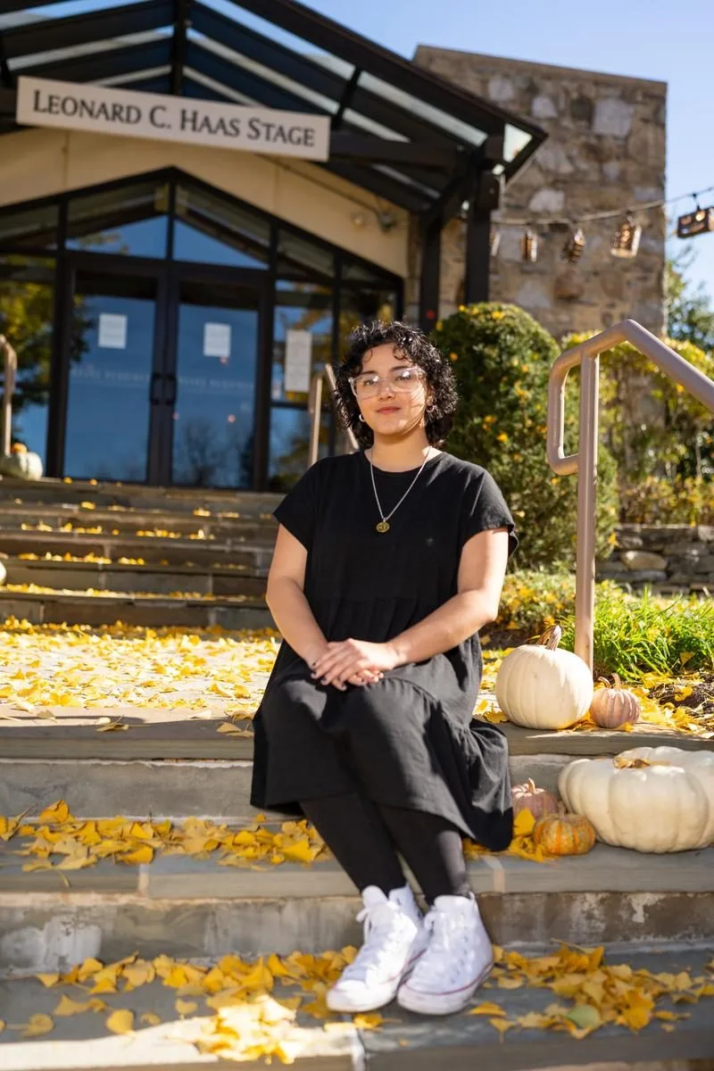 Bryanna Martinez-Jiminez '22 sits in front of People's Light theater on a Fall day.