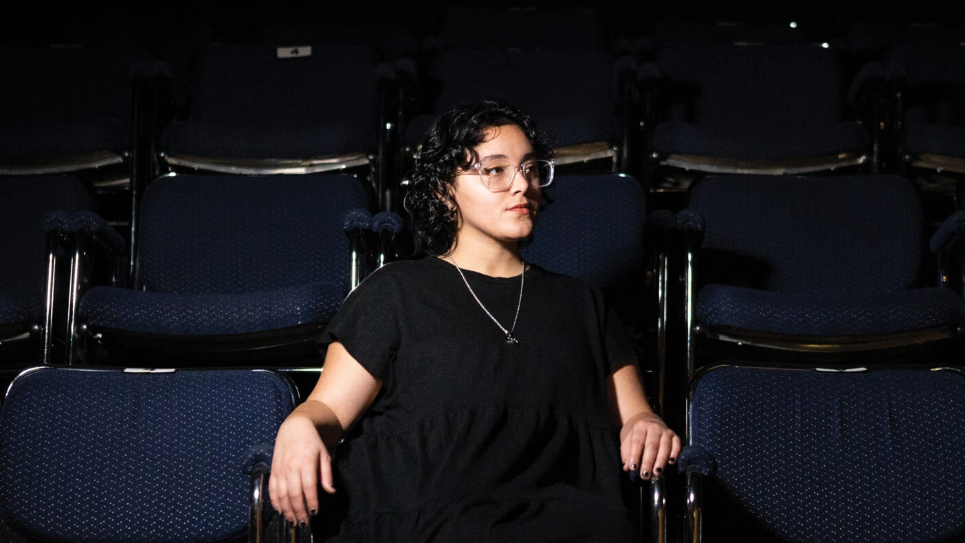 Bryanna Martinez-Jimenez '22 sitting in theater