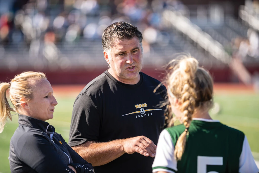 Tom DeGeorge '04 coaching the girls' soccer team at Archbishop Wood
