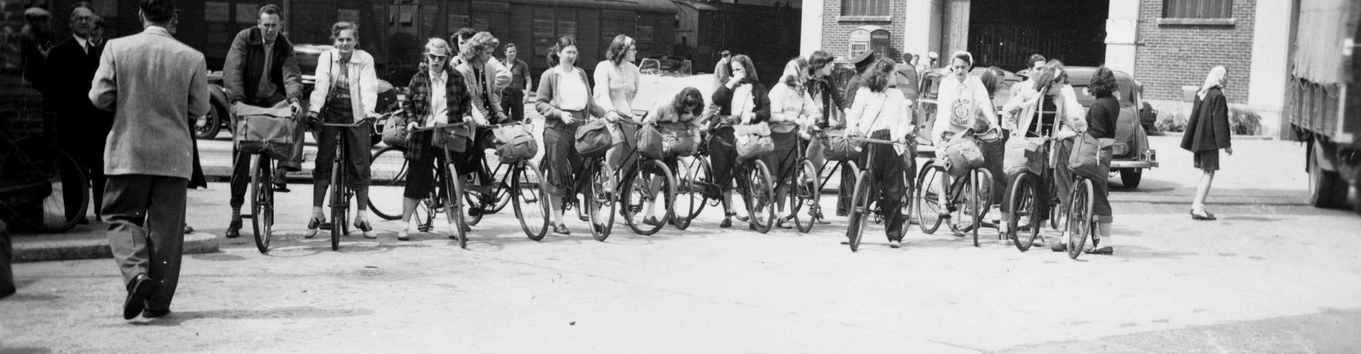 Students ride bicycles in Amsterdam during the 1940s.