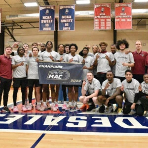 Arcadia Mens Basketball team gathers for a photo, post-championship game with Middle Atlantic Conference Championship 2023 Banner