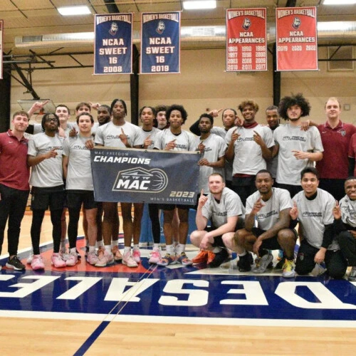 Arcadia Mens Basketball team gathers for a photo, post-championship game with Middle Atlantic Conference Championship 2023 Banner