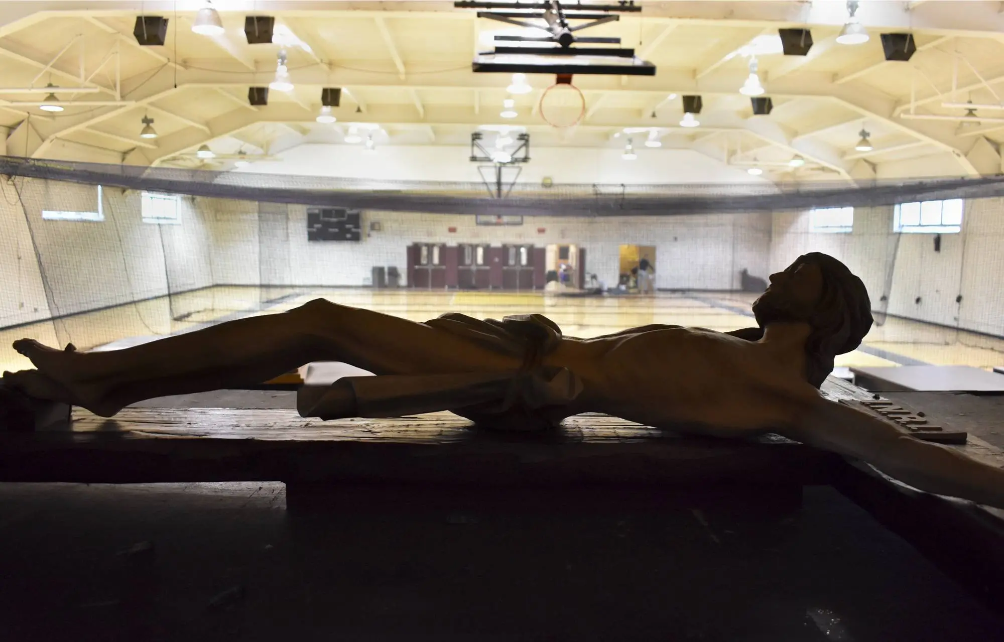 Kelsie Winship ’26 Untitled 2022 Crucifix resting on theater stage in high school gymnasium.