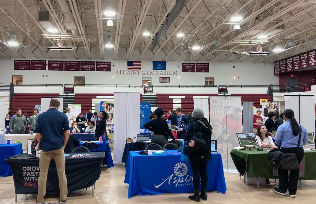 Tables of employers in the Kuch Alumni Gym for the 2023 Internship and Career Fair
