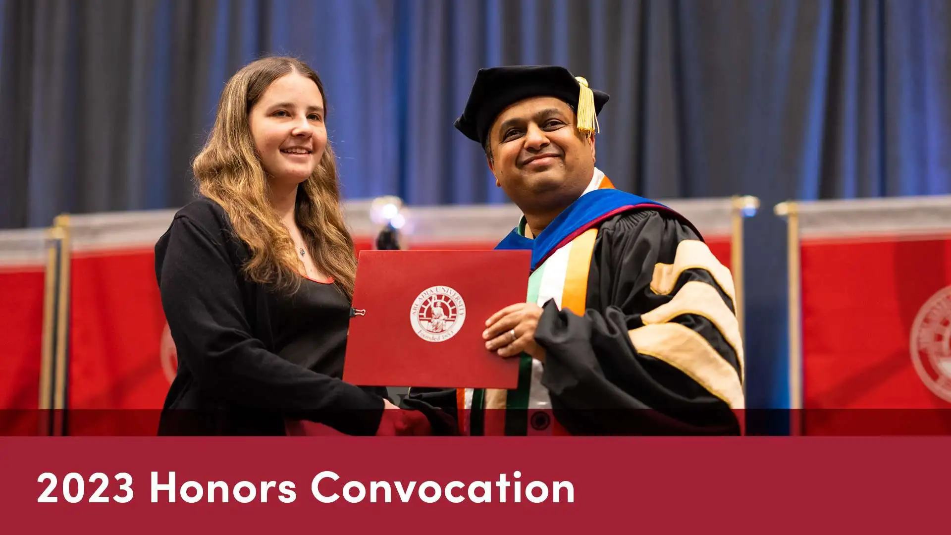 Honors Convocation Thumnail with a student receiving an award from the head of the School of Global Business