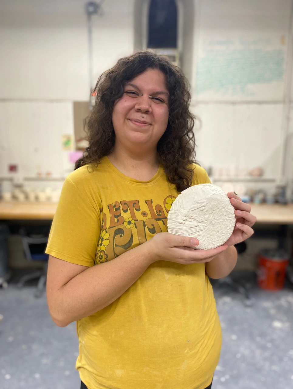 Angie Brewer holds up one of her Ceramic pieces