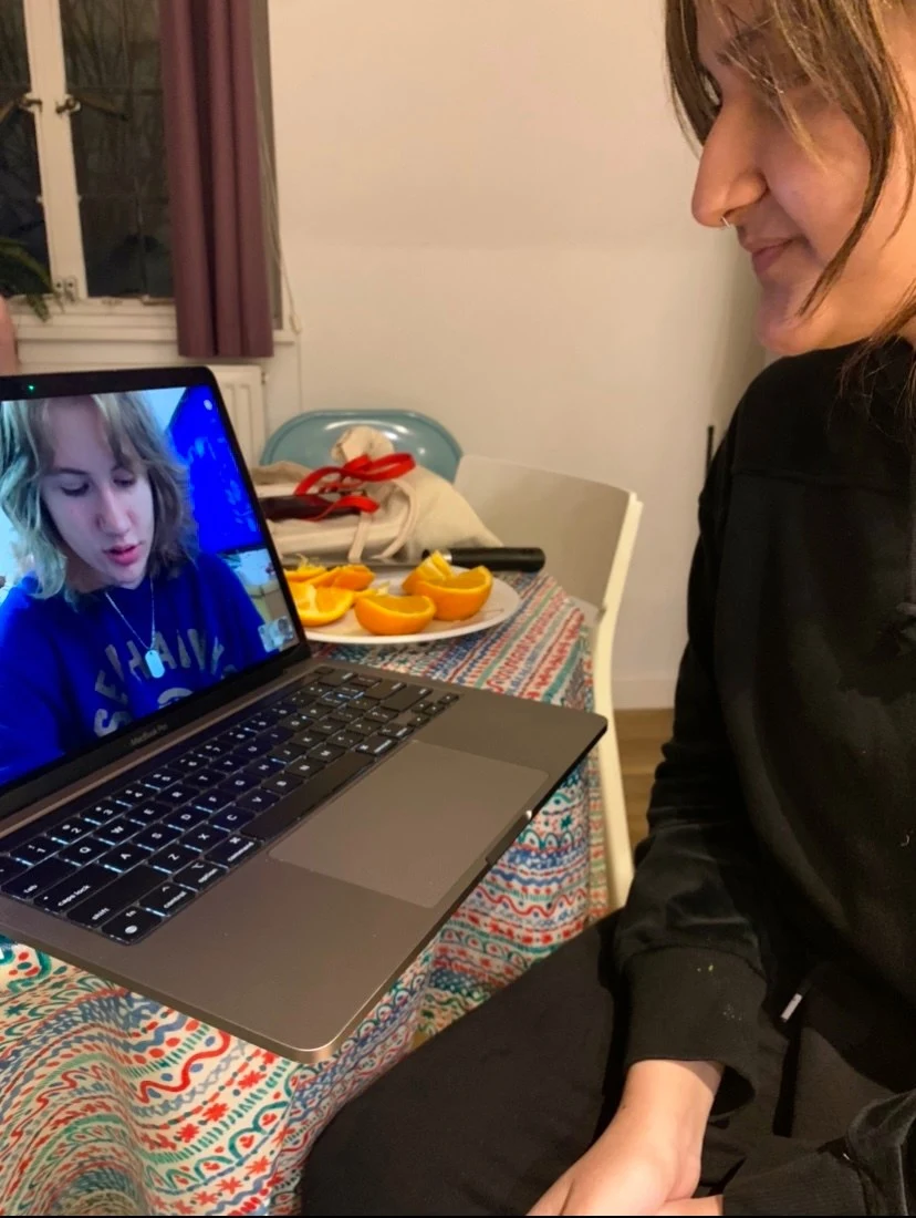 A student video chats with a loved one on a computer
