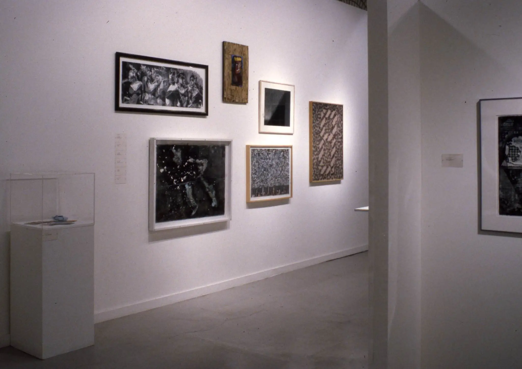 A white room gallery showing different artworks on the wall