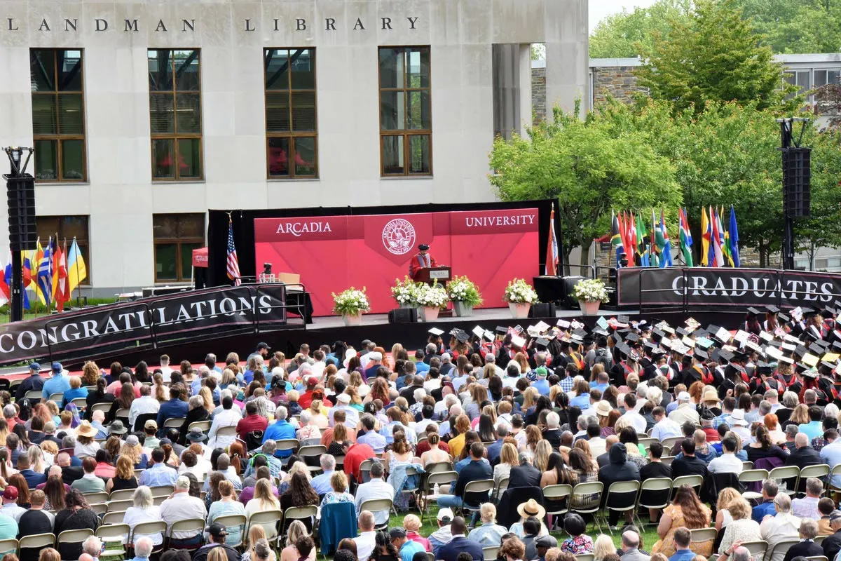 President Nair giving a speech to a crowd of families and graduating students