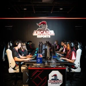 The Arcadia esports team sitting in a row on the computers