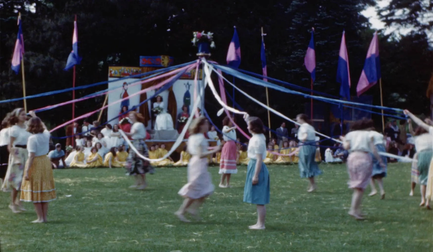 still from 1948 color film footage of Beaver College students dancing around the may pole during May Day celebration.