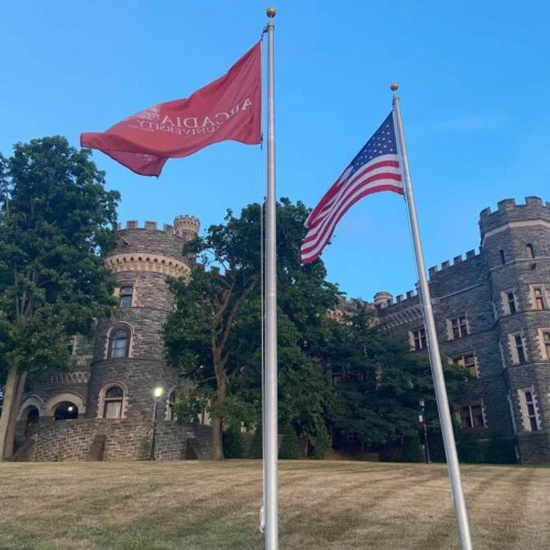 The U.S. flag and the Arcadia flag in front of Grey Towers Castle.