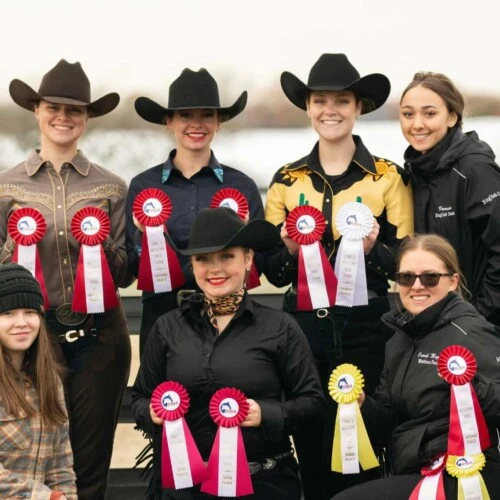 Arcadia's Equestrian Team posing with their award ribbons.