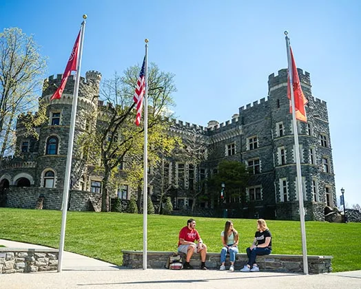 Flags wave in front of the Castle on the Arcadia campus.