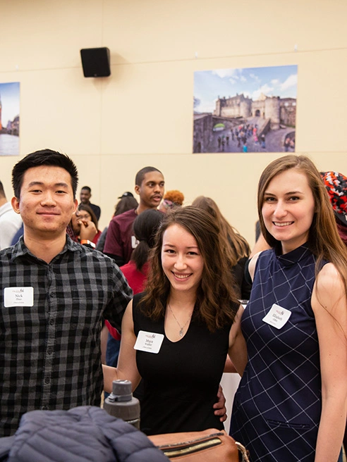Maya Walke, Marketing Concentration student stands with two other undergraduates at a Knights 4 event.