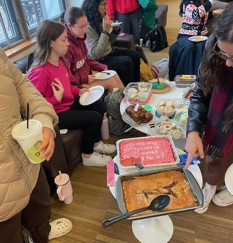 Students eating baked treats for a cause.