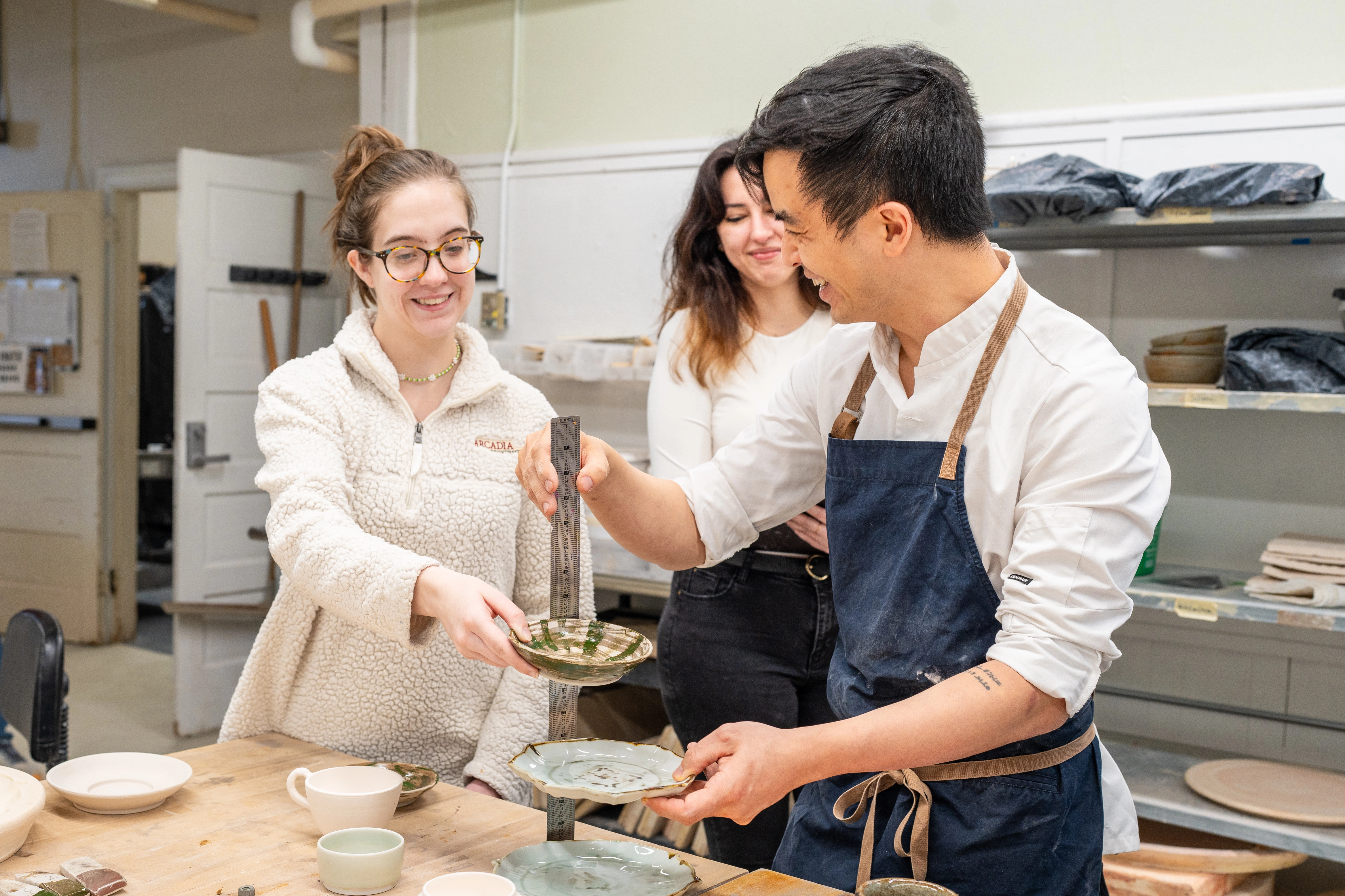 Chef Rhee working with ceramics students.